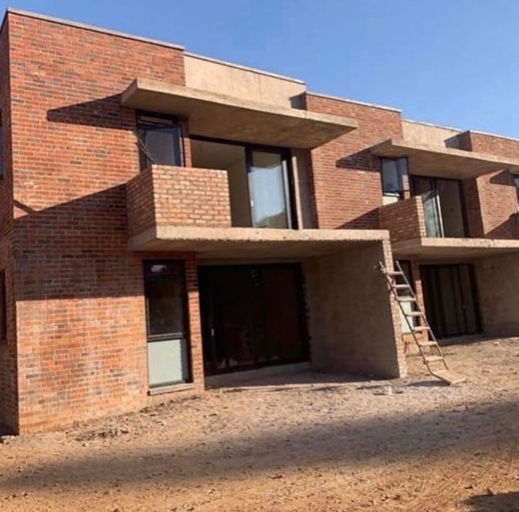 Face-brick cluster housing development under construction in Borrowdale Harare with cast concrete balconies