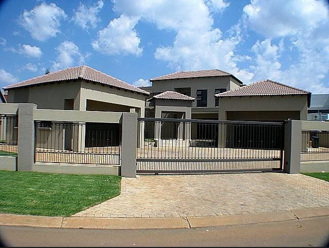 Completed three-pavilion family residence with tiled roofs, automated gate and cobbled driveway in Johannesburg, South Africa